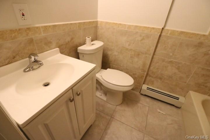 73 Main Street, Unit 2 Walden, NY 12586 - Photo 3 of 7 a bathroom with a sink a toilet and a mirror