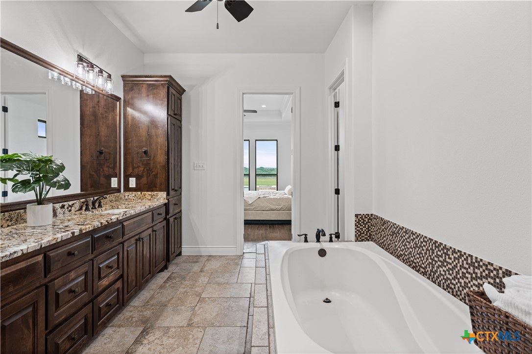 11023 Bigham Road Troy, TX 76579 - Photo 24 of 42 a spacious bathroom with a bathtub sink and mirror