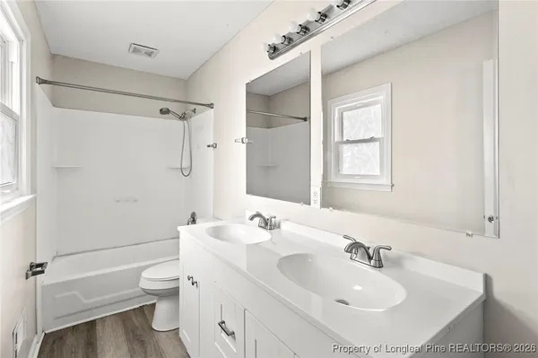 a bathroom with a bath tub with a shower