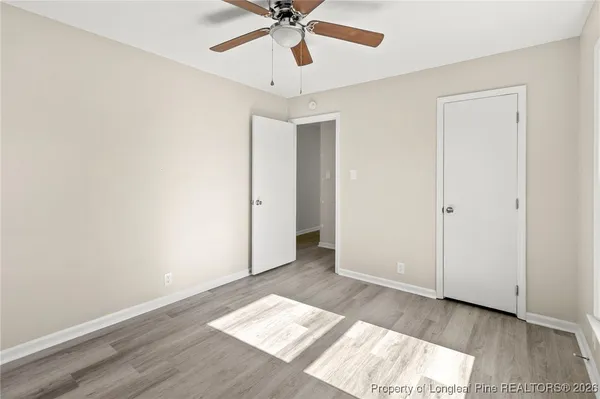 a balcony with wooden floor and fence