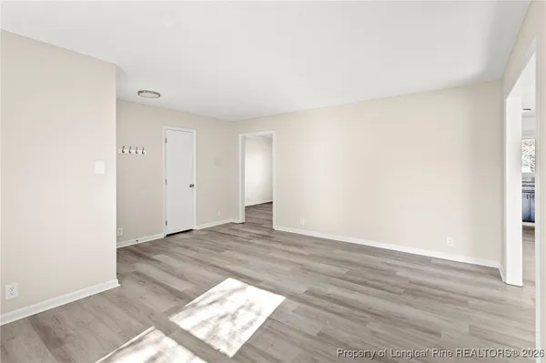 a view of an empty room and wooden floor