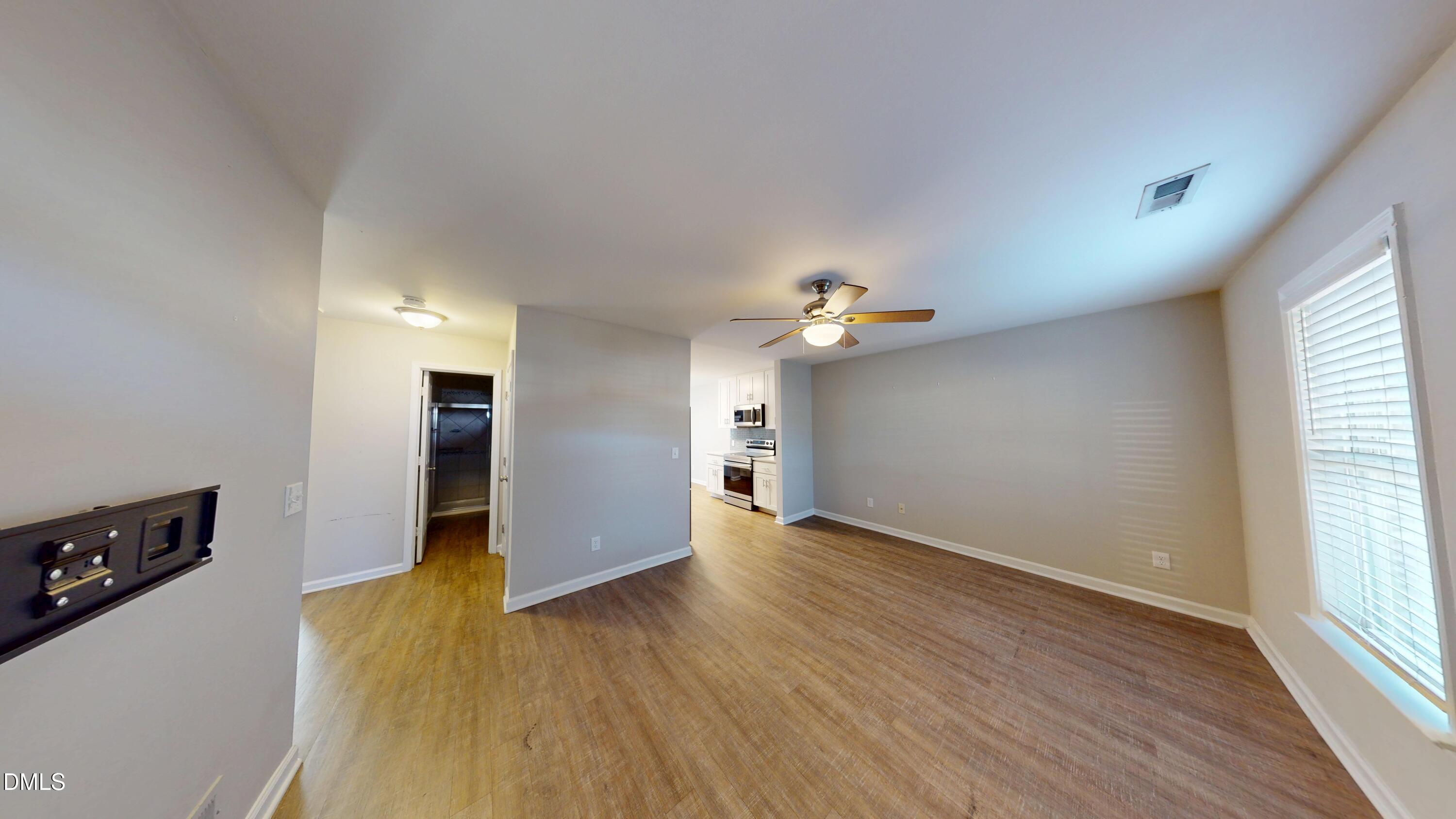 1312 South State Street, Unit A Raleigh, NC 27610 - Photo 2 of 12 wooden floor in an empty room with a window