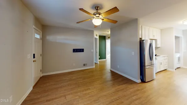 wooden floor in an empty room with a window