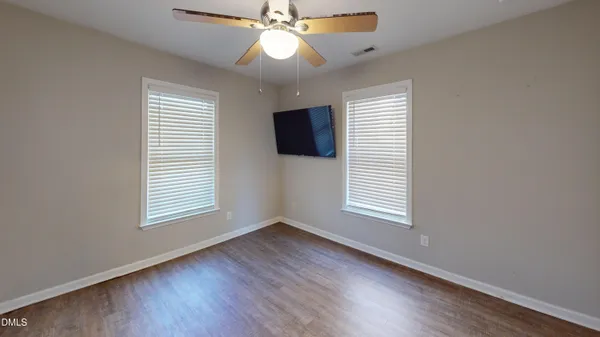 a view of wooden floor and brick walls