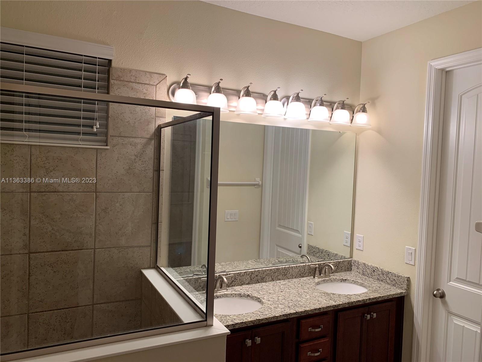 13832 Summerport Trail Loop Windermere, FL 34786 - Photo 13 of 39 a bathroom with a double vanity sink and mirror