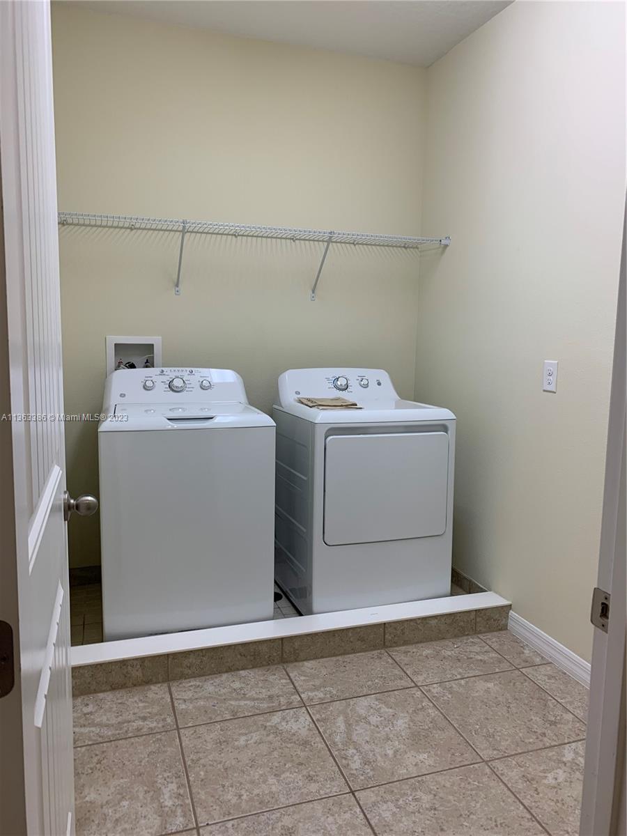 13832 Summerport Trail Loop Windermere, FL 34786 - Photo 20 of 39 a utility room with dryer and washer