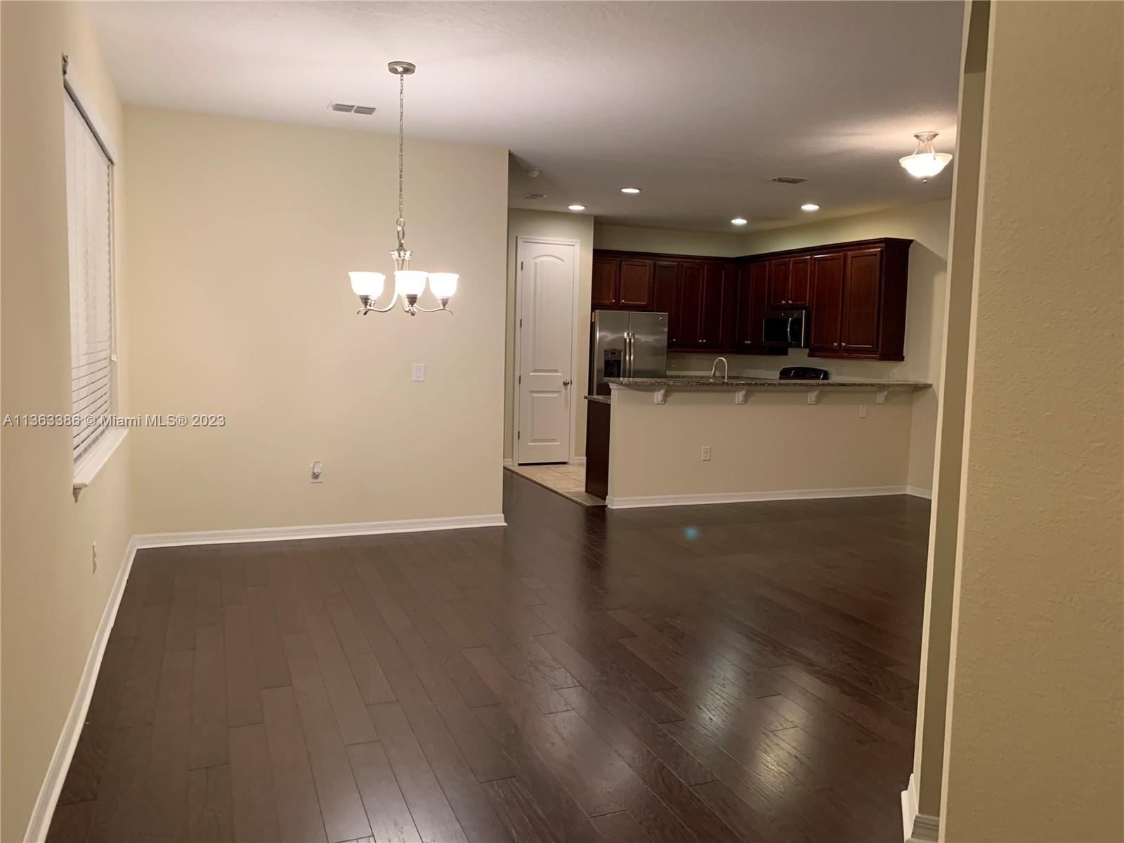 13832 Summerport Trail Loop Windermere, FL 34786 - Photo 5 of 39 a view of a kitchen with a sink and dishwasher a refrigerator with wooden floor