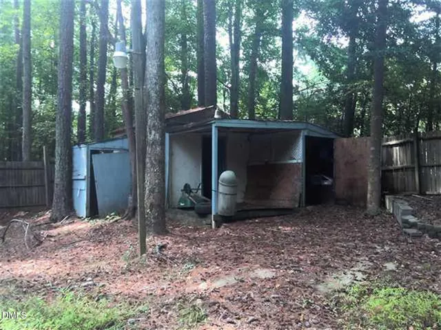 a backyard of a house with lots of green space and fountain