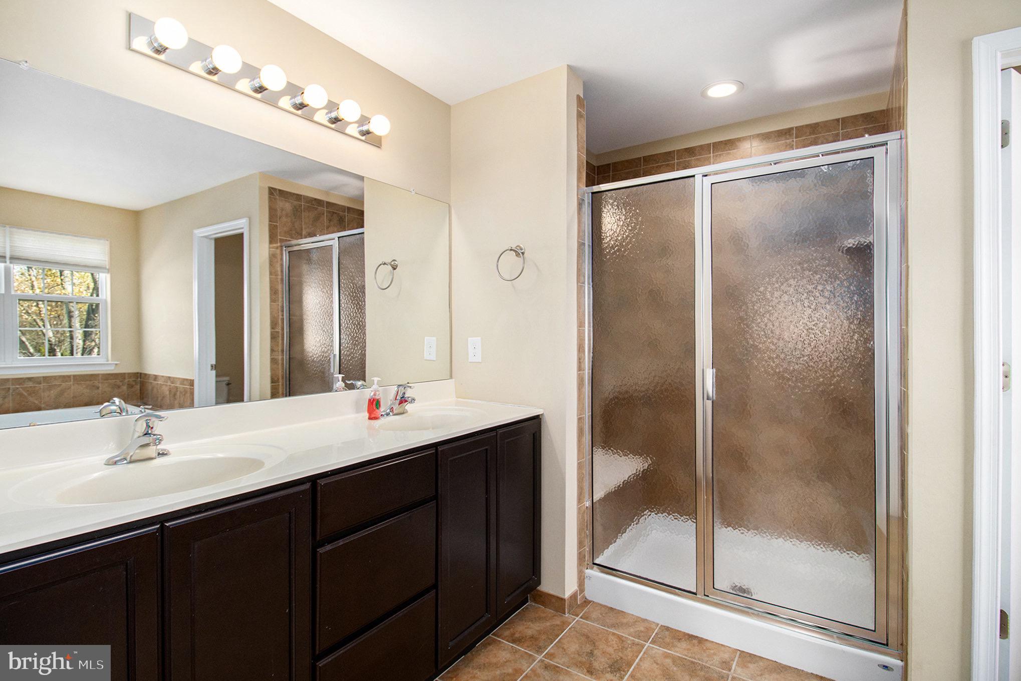 1226 Cabin Road Hatfield, PA 19440 - Photo 17 of 28 a bathroom with a shower sink and mirror