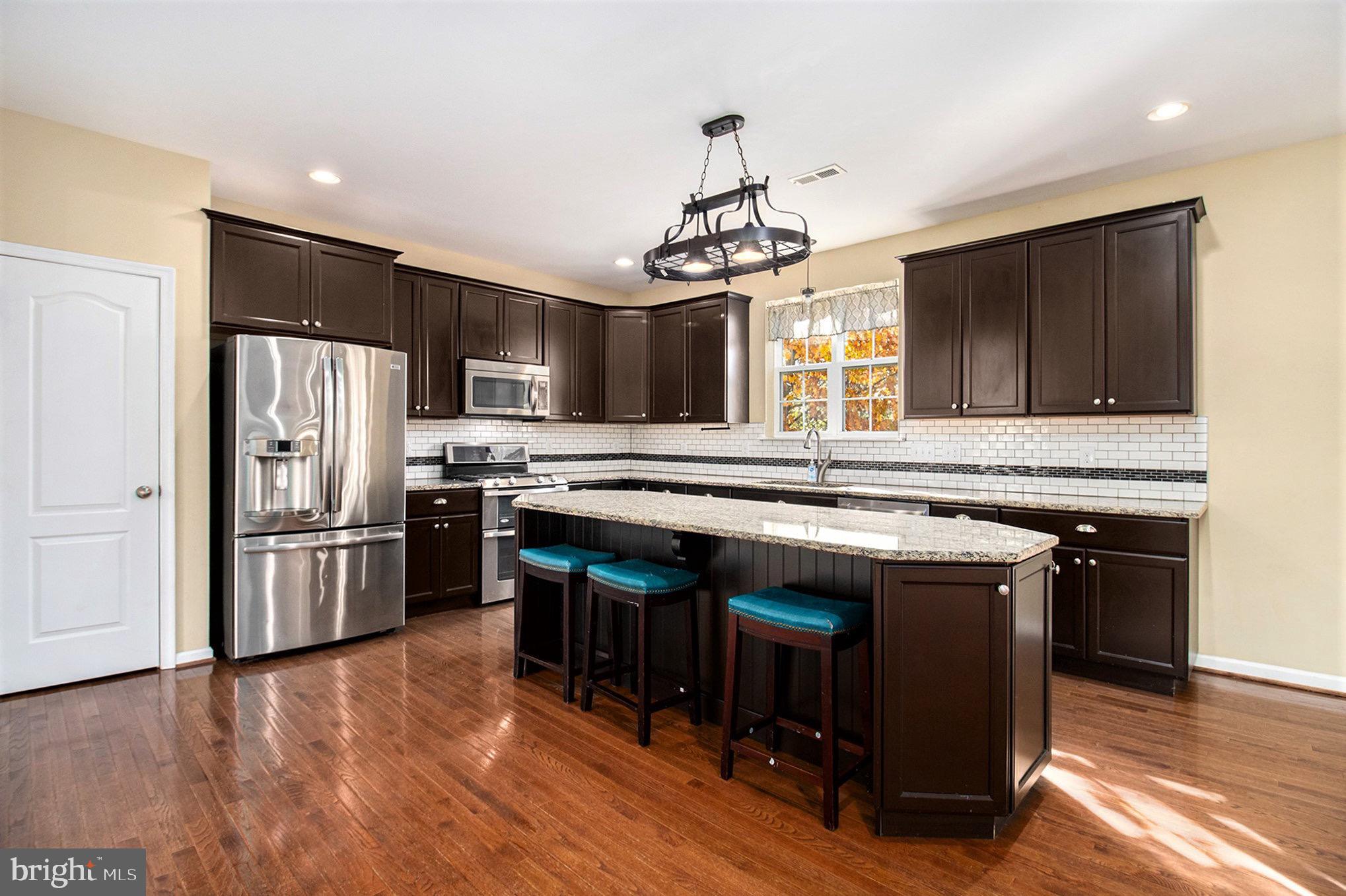 1226 Cabin Road Hatfield, PA 19440 - Photo 8 of 28 a kitchen with stainless steel appliances granite countertop a stove refrigerator and microwave