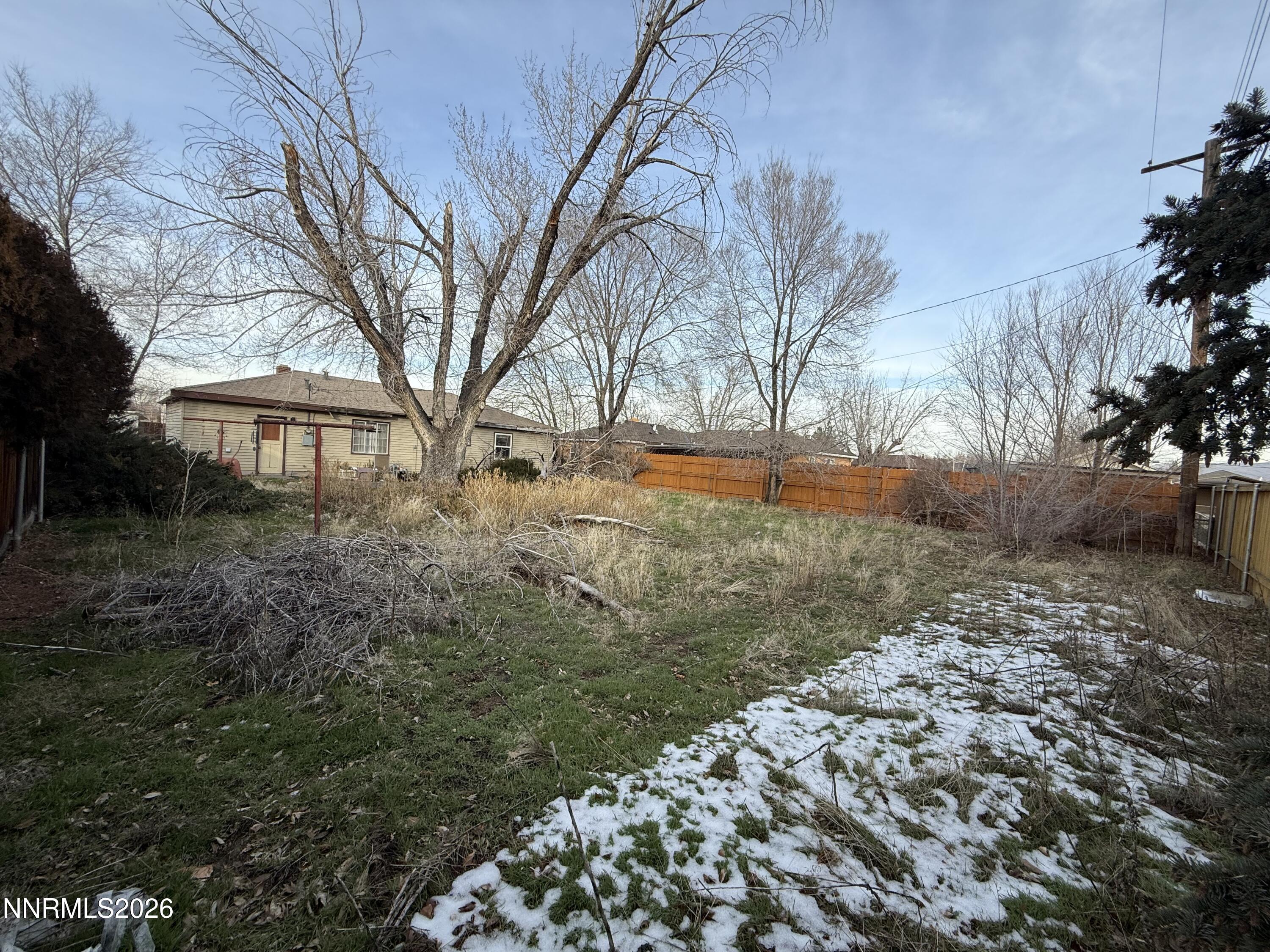 870 Capitol Hill Avenue Reno, NV 89502 - Photo 20 of 24 a backyard of a house with large trees and covered with wooden fence