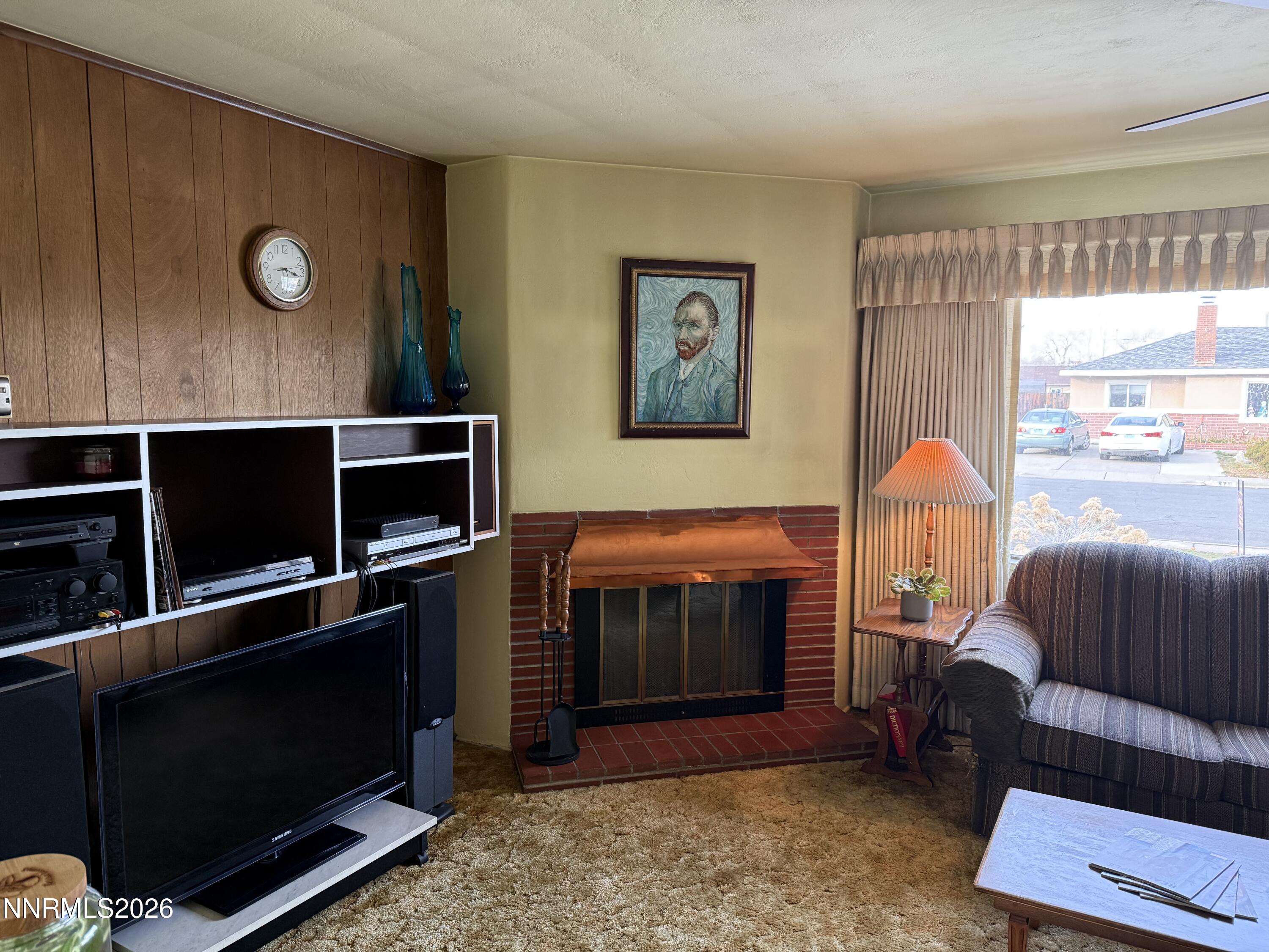 870 Capitol Hill Avenue Reno, NV 89502 - Photo 9 of 24 a living room with furniture a flat screen tv and a fireplace