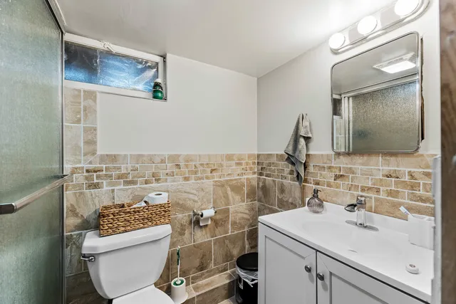 a bathroom with a sink toilet and mirror