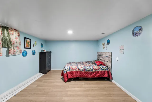 a bedroom with a bed and a dresser