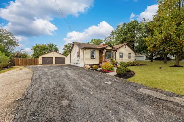 a view of a house with a yard and fence