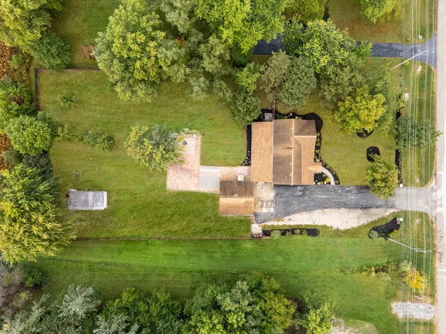 a aerial view of a house with a yard