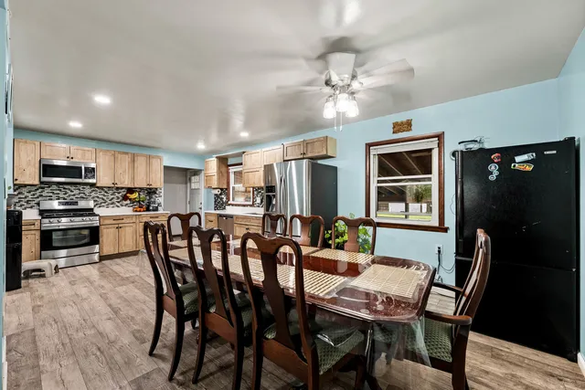 a view of a dining room with furniture and chandelier