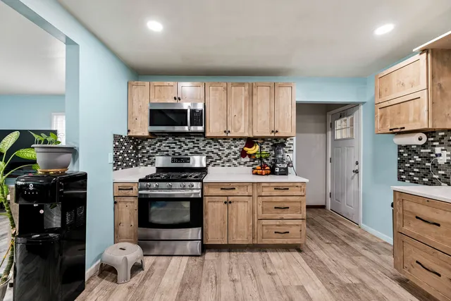 a kitchen with a stove oven and a refrigerator