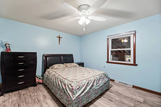 a bedroom with a bed a chandelier and a closet