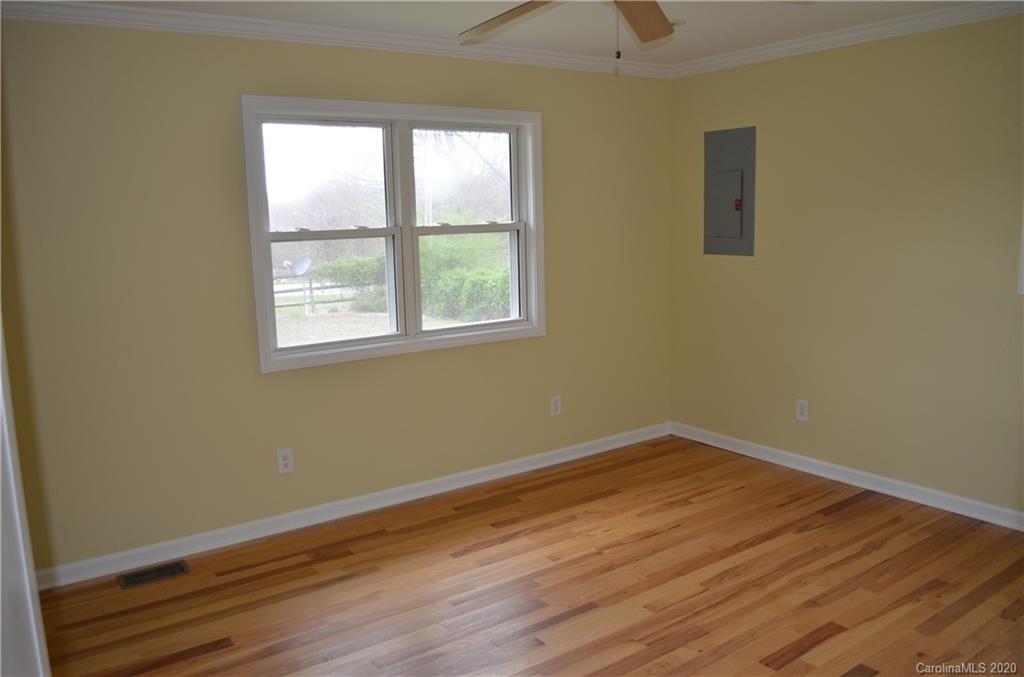 1773 Shearers Road Davidson, NC 28036 - Photo 14 of 19 an empty room with wooden floor and windows