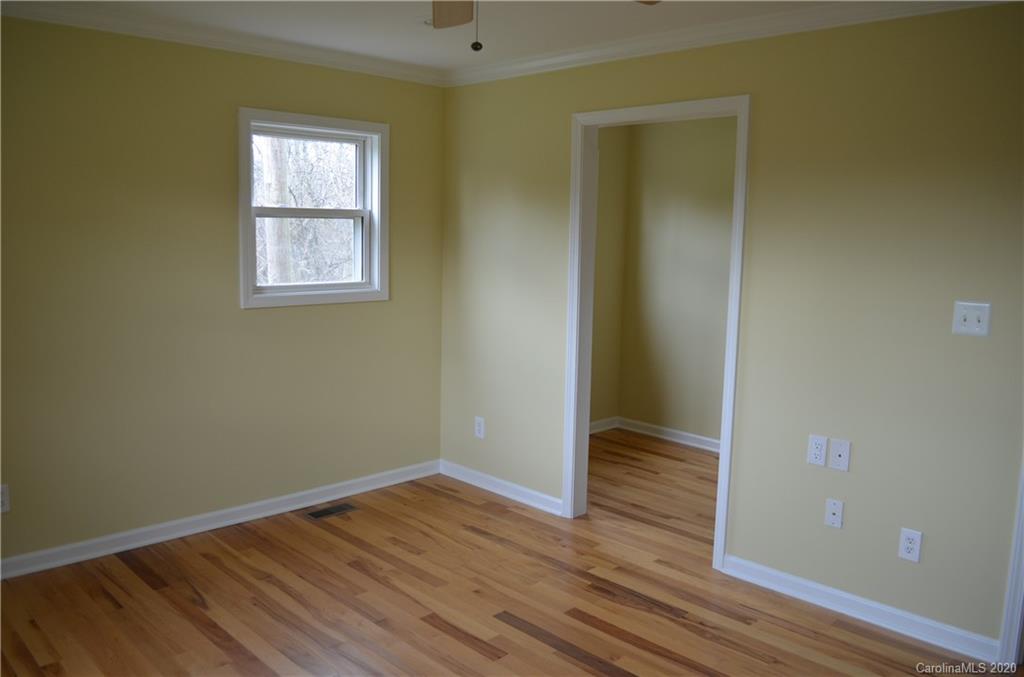 1773 Shearers Road Davidson, NC 28036 - Photo 15 of 19 an empty room with wooden floor and closet