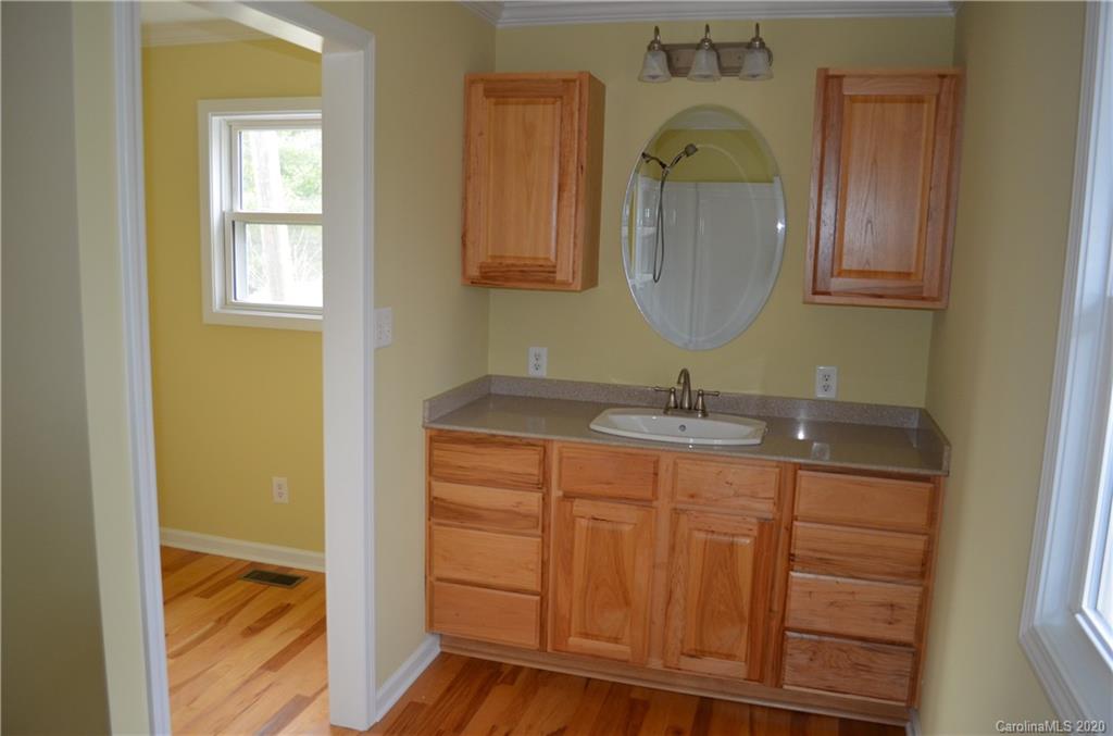 1773 Shearers Road Davidson, NC 28036 - Photo 17 of 19 a bathroom with a granite countertop sink and a mirror