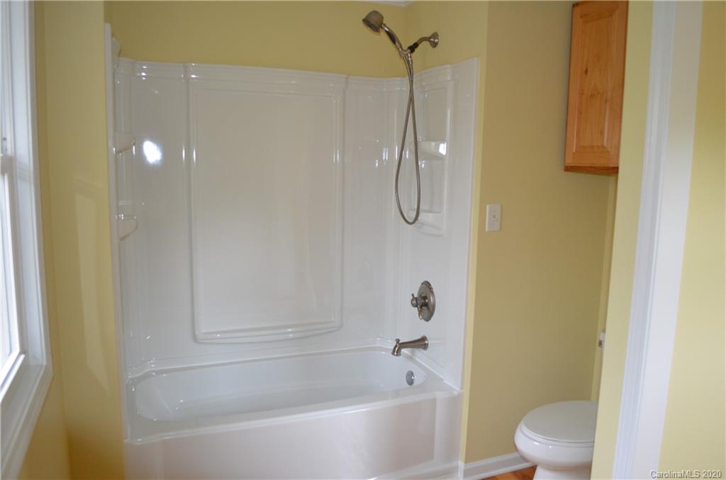 1773 Shearers Road Davidson, NC 28036 - Photo 18 of 19 a bathroom with a bathtub and a shower