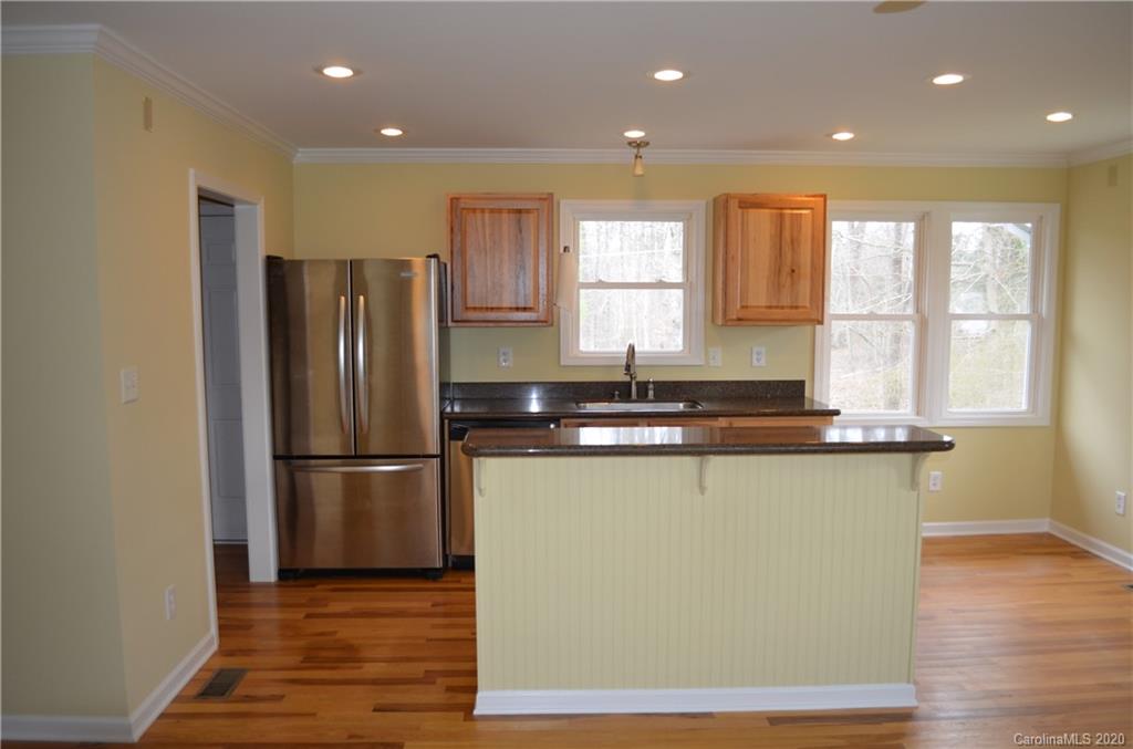1773 Shearers Road Davidson, NC 28036 - Photo 7 of 19 a kitchen with stainless steel appliances granite countertop a refrigerator a sink and a stove