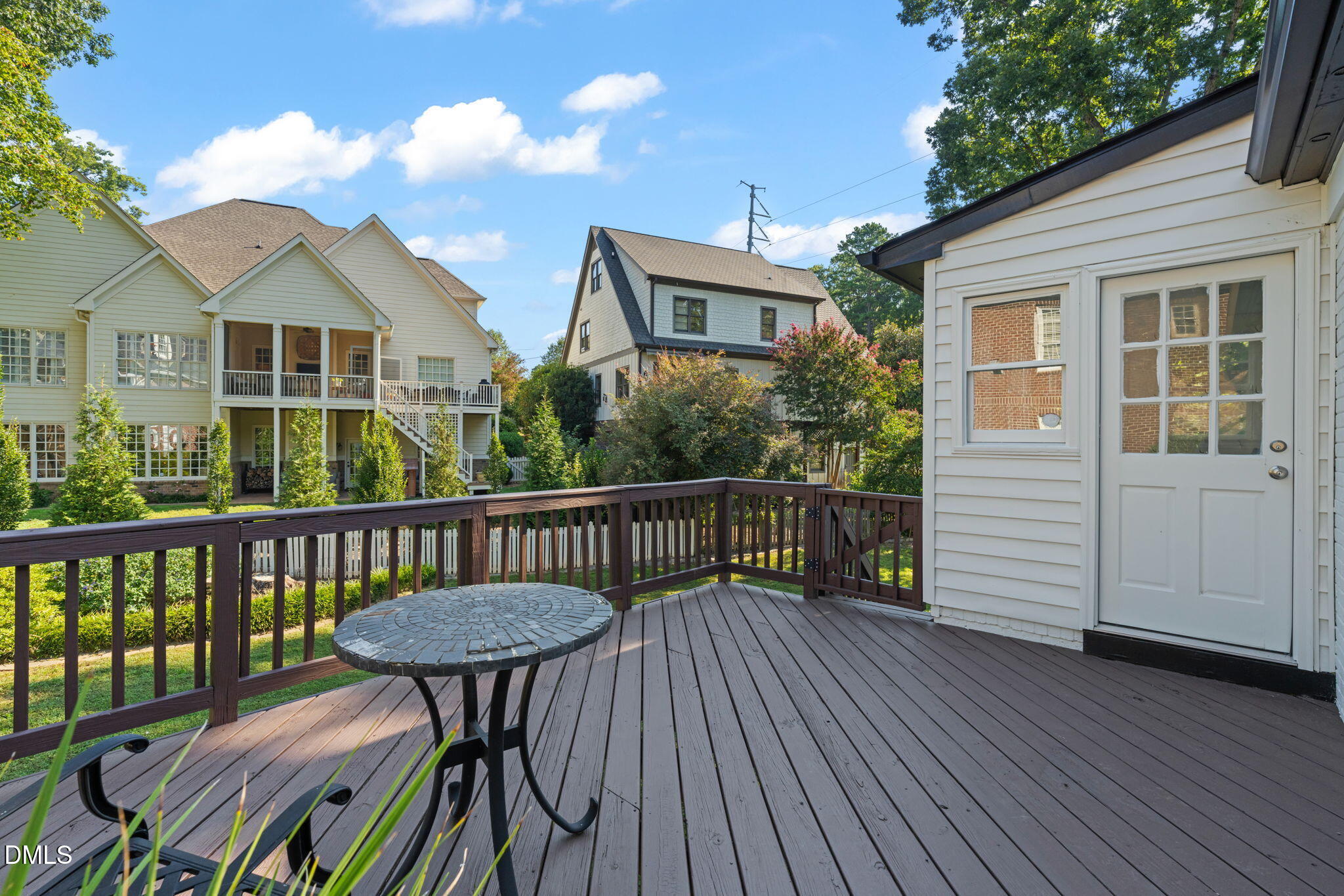 406 Chesterfield Road Raleigh, NC 27608 - Photo 10 of 25 a view of a deck with wooden floor chairs and a barbeque