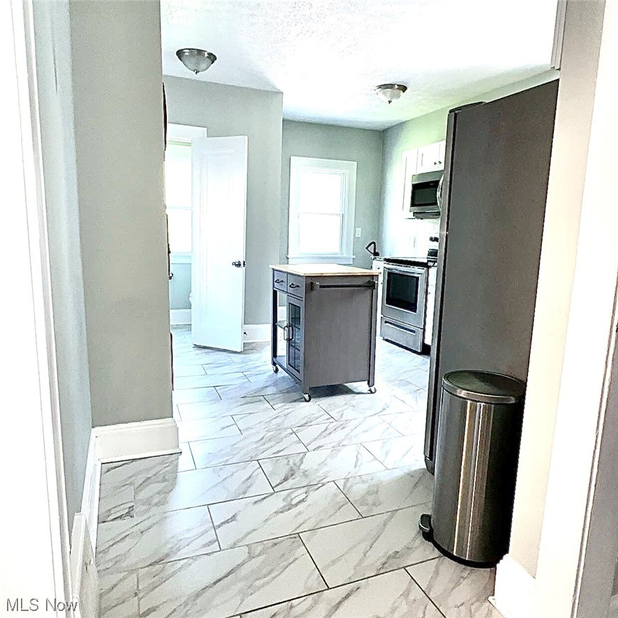 1055 Hillstone Road Cleveland Heights, OH 44121 - Photo 2 of 16 Kitchen featuring stainless steel appliances and light tile floors