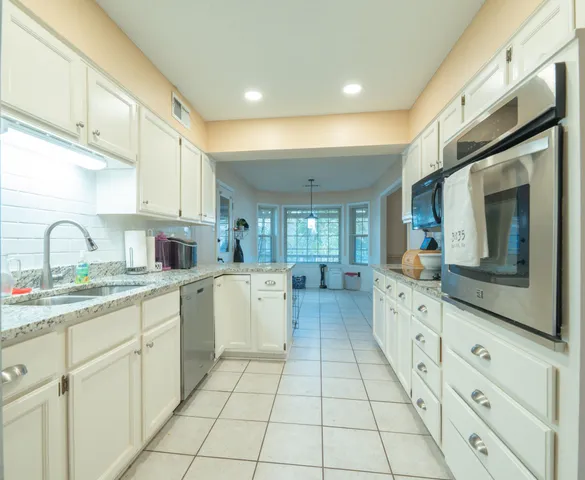 a kitchen with sink cabinets and window