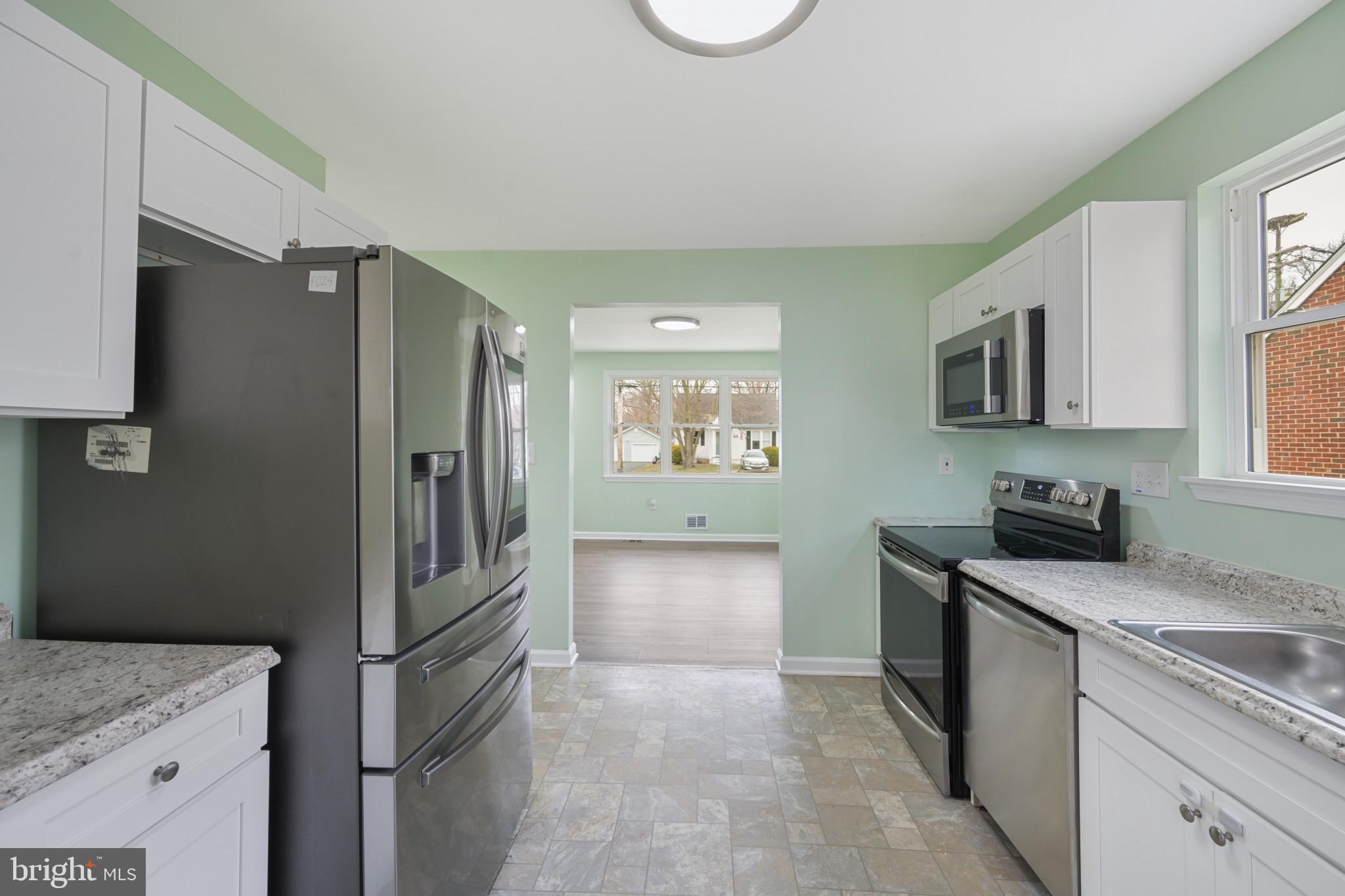 323 Wye Road Essex, MD 21221 - Photo 11 of 35 a kitchen with a refrigerator stove and sink