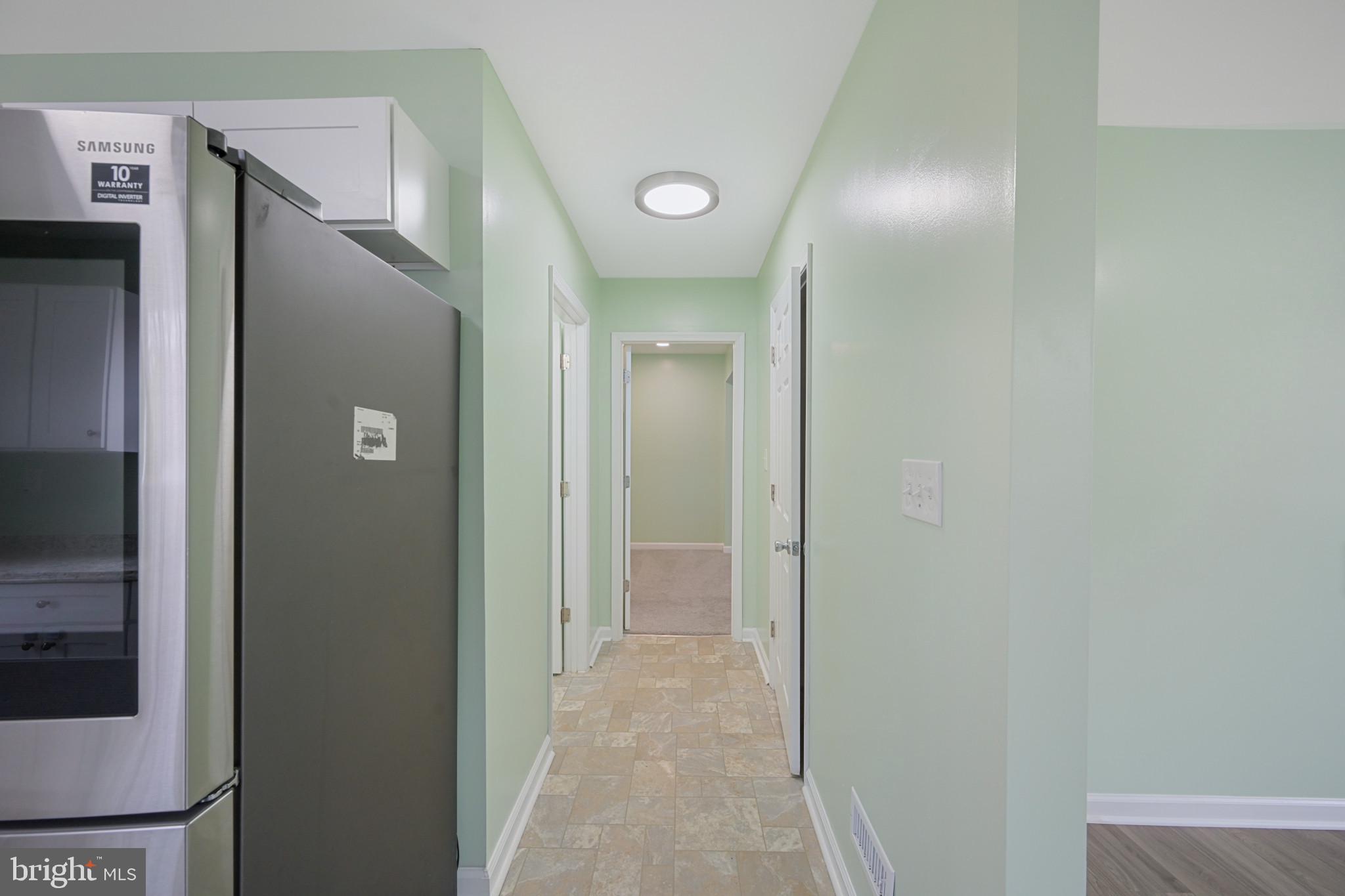 323 Wye Road Essex, MD 21221 - Photo 12 of 35 a view of a hallway with wooden cabinets