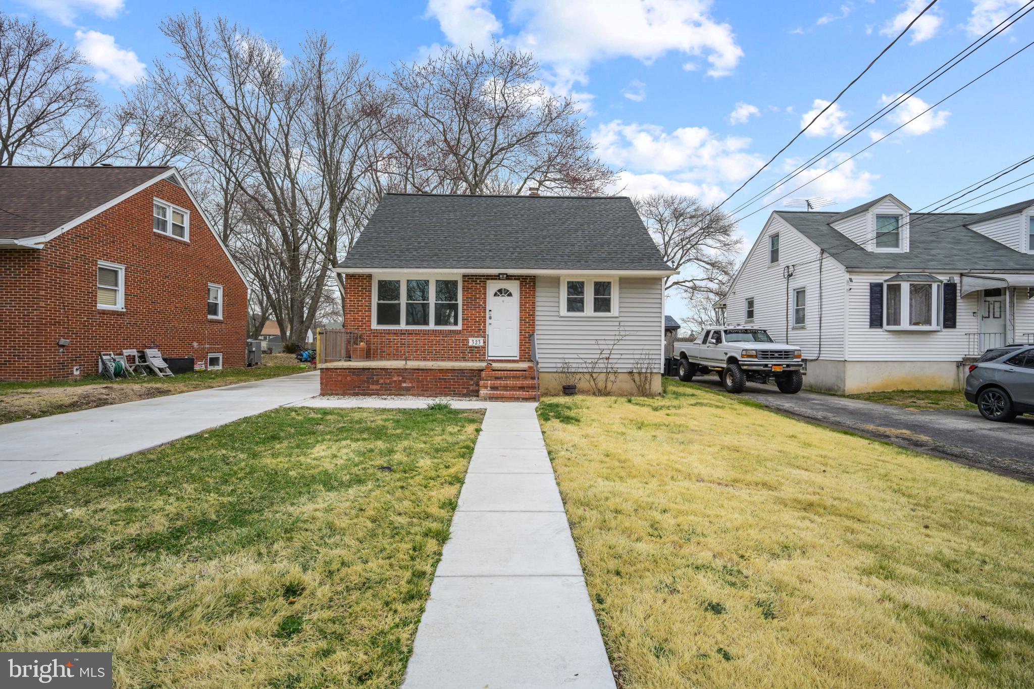 323 Wye Road Essex, MD 21221 - Photo 2 of 35 a front view of a house with a yard