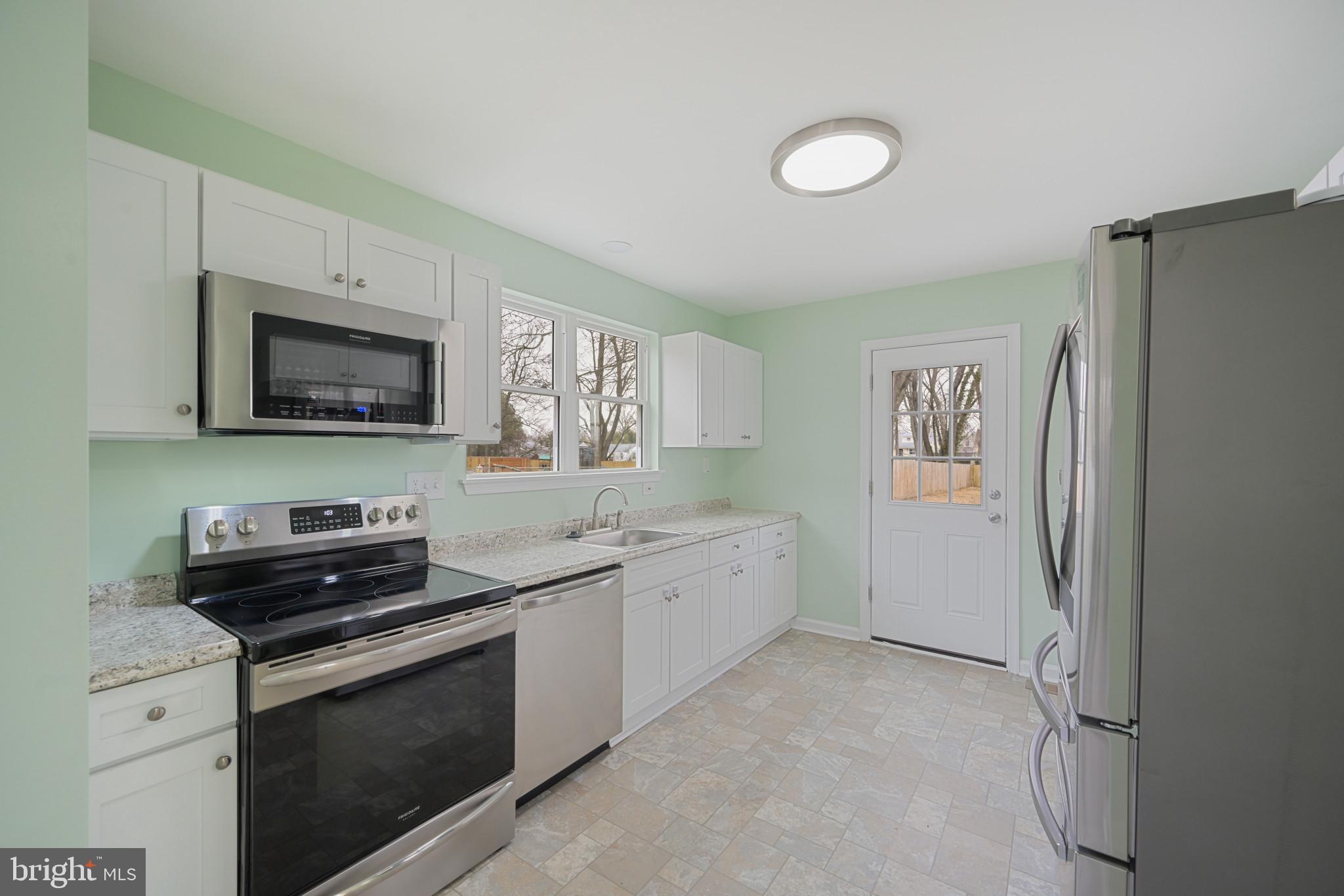 323 Wye Road Essex, MD 21221 - Photo 4 of 35 a kitchen with a sink stove and microwave