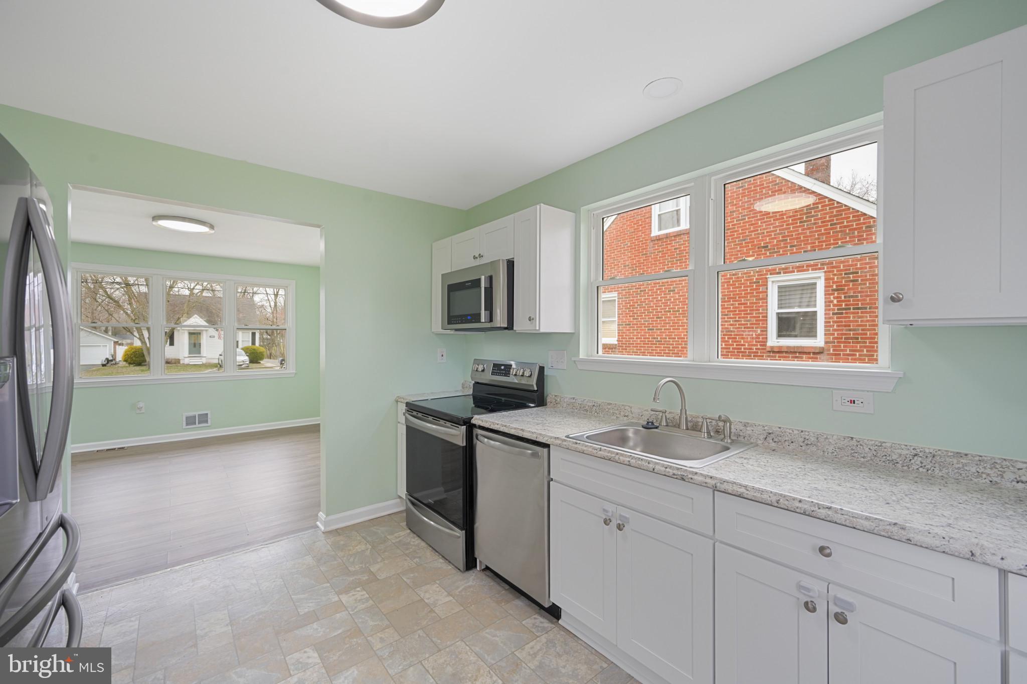 323 Wye Road Essex, MD 21221 - Photo 5 of 35 a spacious bathroom with a granite countertop sink mirror and a bathtub