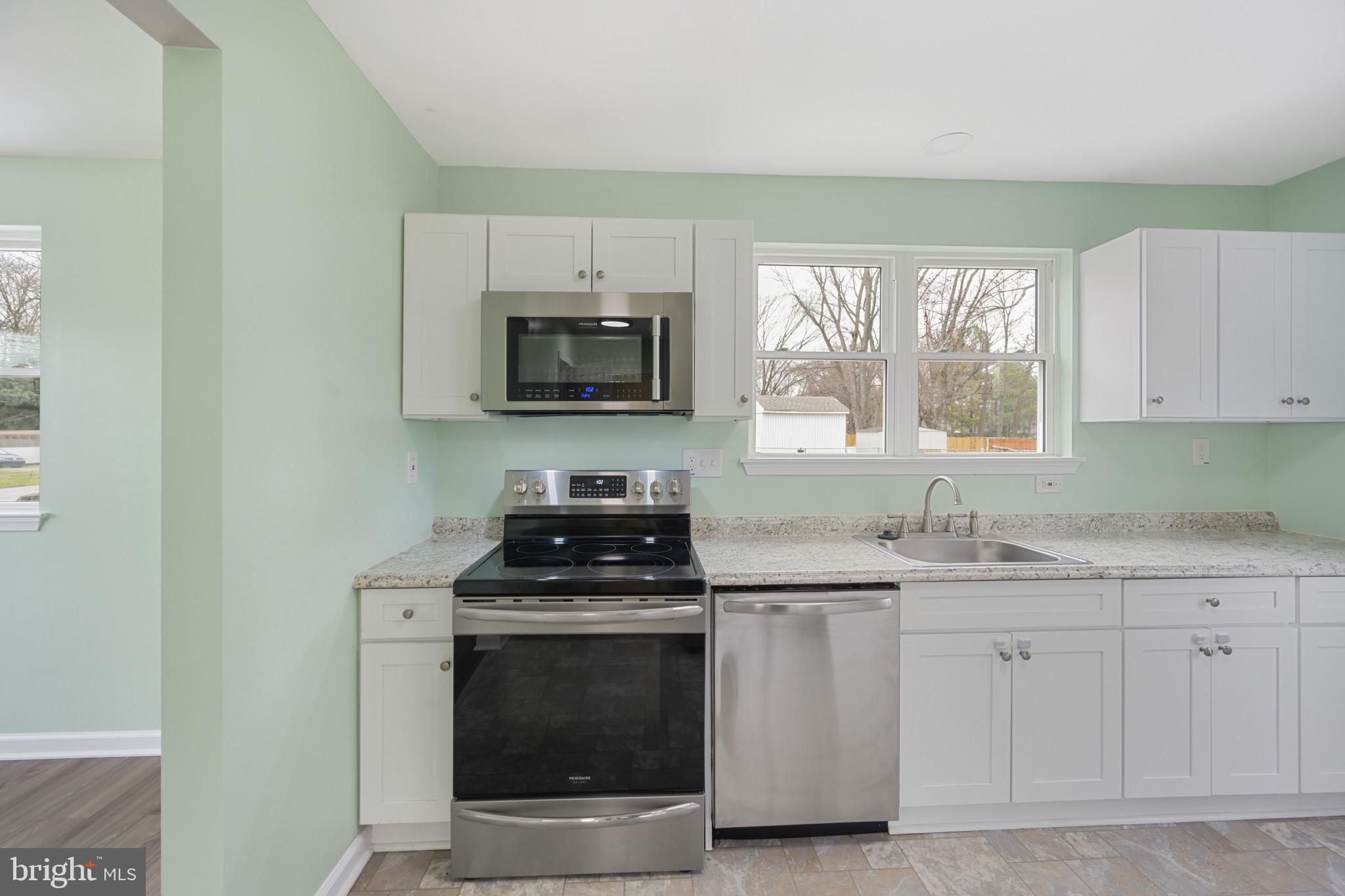 323 Wye Road Essex, MD 21221 - Photo 10 of 35 a kitchen with cabinets stainless steel appliances a sink and a window