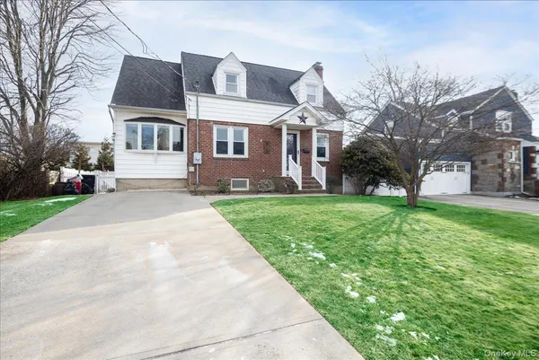 a front view of house with yard and green space