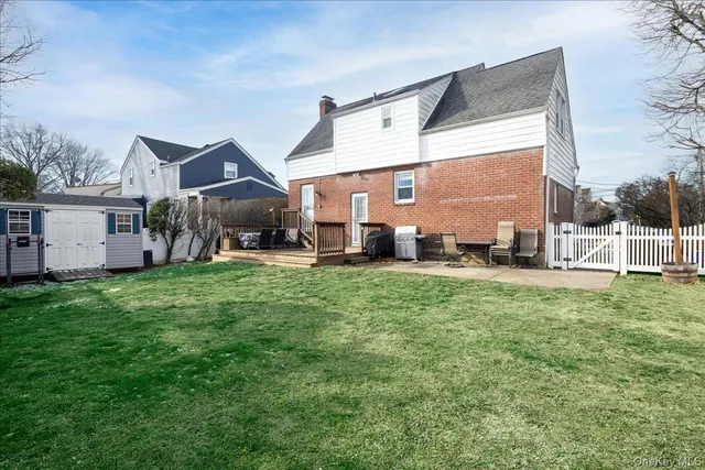 a front view of a house with a yard table and chairs