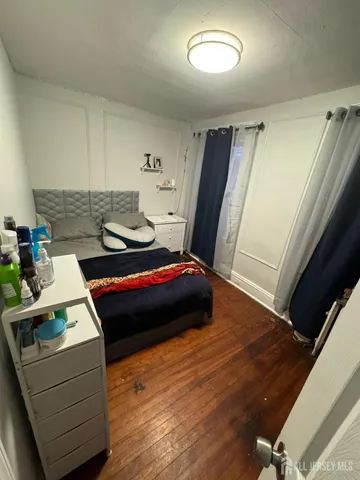 a living room with a bed and a window