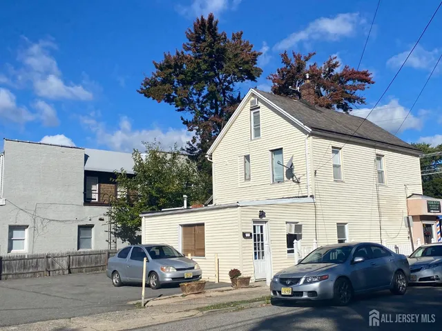 a view of a white house with a yard