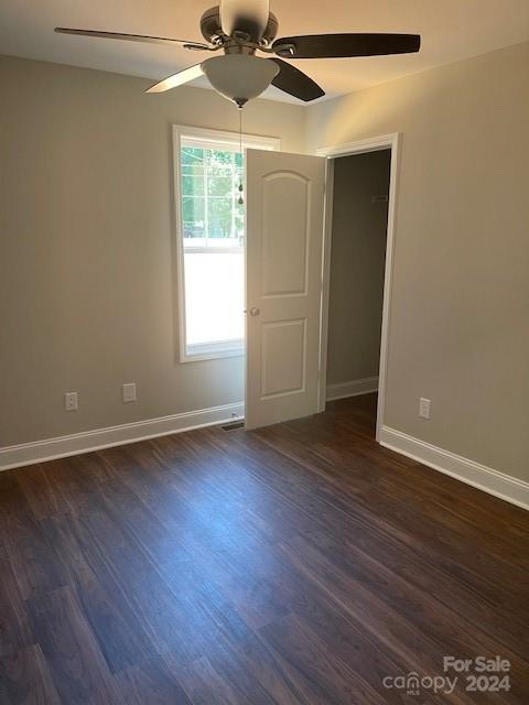 1545 West Ridge Road Salisbury, NC 28147 - Photo 13 of 18 an empty room with wooden floor chandelier fan and windows