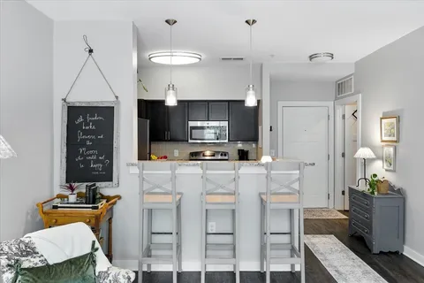 a kitchen with a refrigerator a stove top oven a sink and cabinets