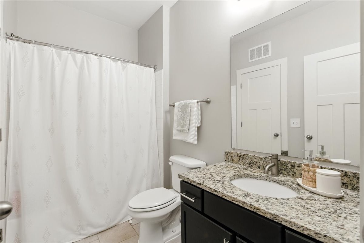 414 Rosedale Avenue, Unit 211 Nashville, TN 37211 - Photo 11 of 23 a bathroom with a granite countertop sink and a mirror with toilet