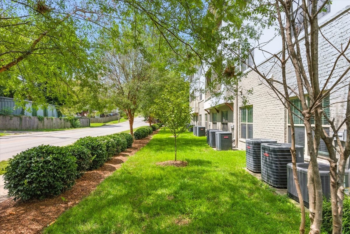 414 Rosedale Avenue, Unit 211 Nashville, TN 37211 - Photo 22 of 23 a view of a backyard with table and chairs and a large tree