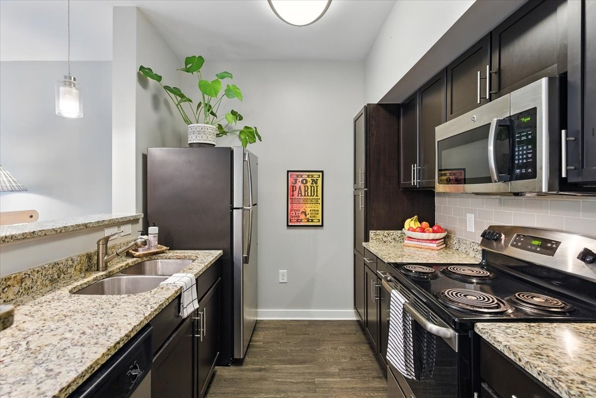 414 Rosedale Avenue, Unit 211 Nashville, TN 37211 - Photo 4 of 23 a kitchen with stainless steel appliances granite countertop a sink stove and refrigerator