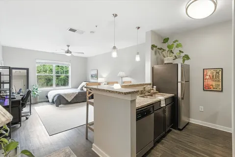 a kitchen with stainless steel appliances granite countertop a stove a sink and a refrigerator