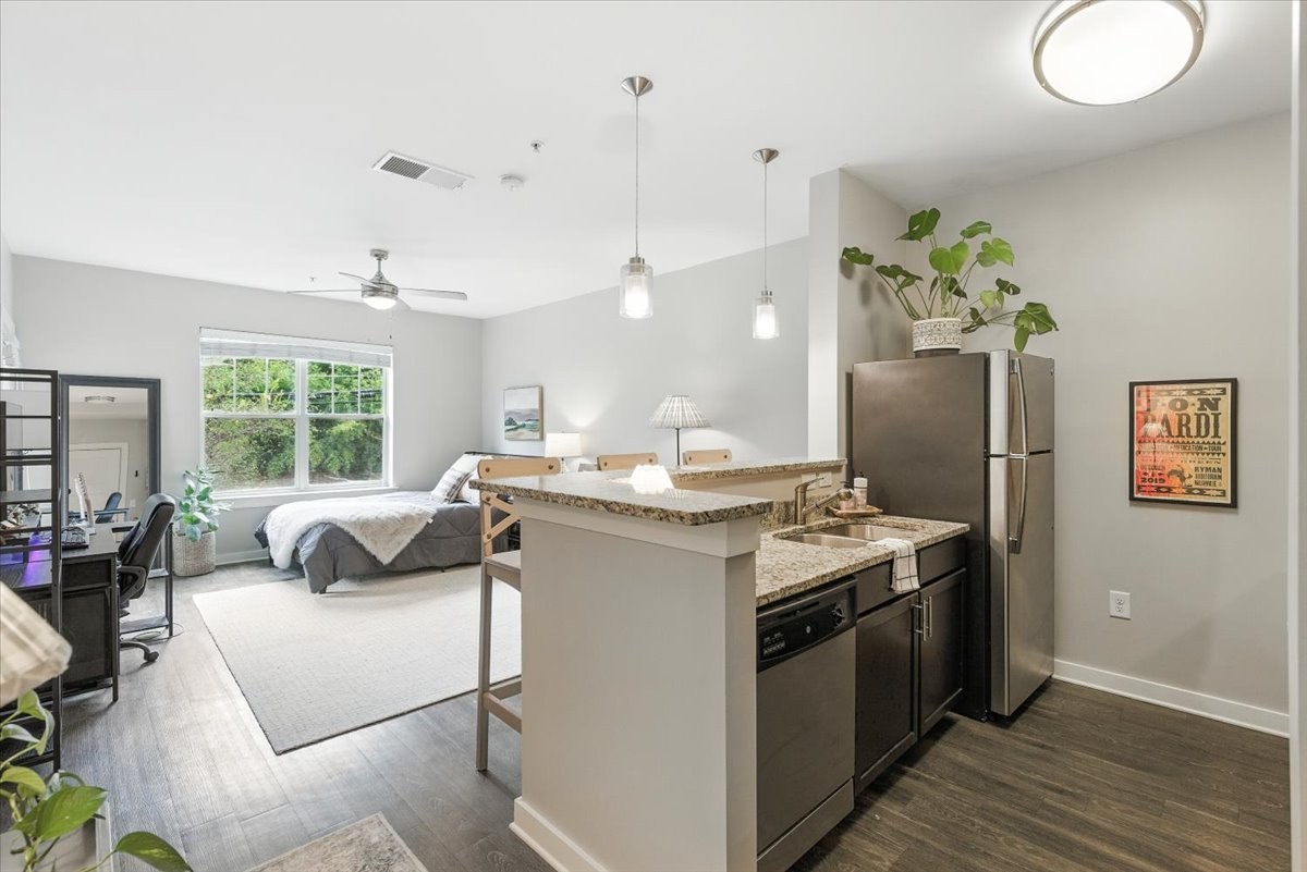 414 Rosedale Avenue, Unit 211 Nashville, TN 37211 - Photo 5 of 23 a kitchen with stainless steel appliances granite countertop a stove a sink and a refrigerator