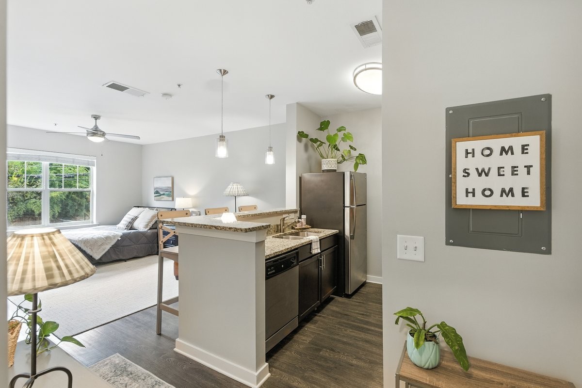 414 Rosedale Avenue, Unit 211 Nashville, TN 37211 - Photo 6 of 23 a kitchen with stainless steel appliances granite countertop a stove a sink and a refrigerator