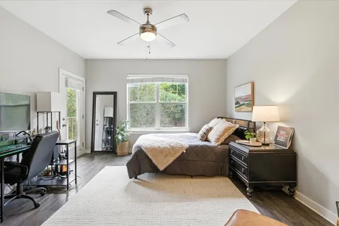 a bedroom with a bed gym equipment and a desk